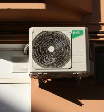A Ballu air conditioner condenser unit mounted on a building exterior, showcasing modern HVAC technology.